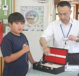 心音計で拍動の音を聞いています。