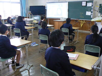 教室でオンライン終業式に参加する児童